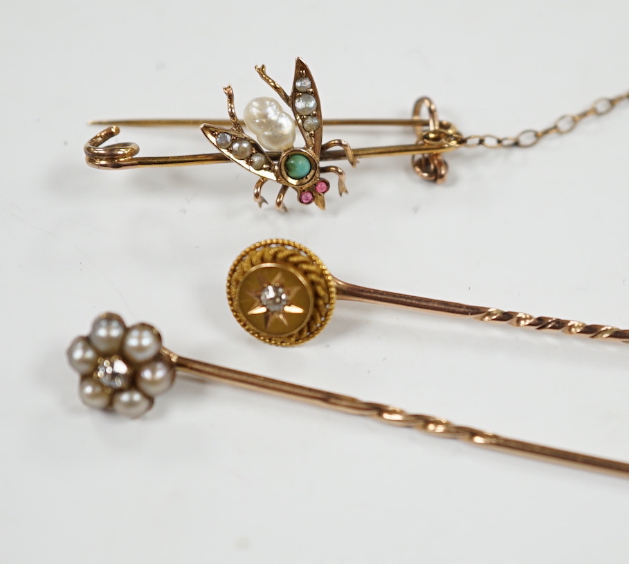 An early 20th century 9ct and gem set bug brooch, 34mm and two yellow metal stick pins, diamond and diamond and seed pearl set.